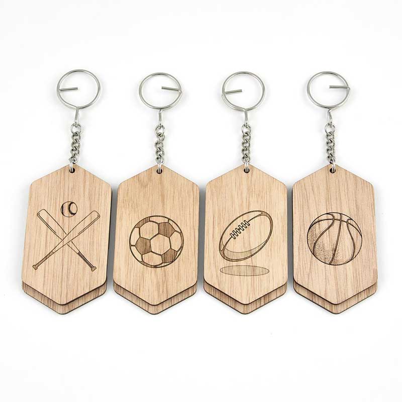 wooden id tags with baseball bats, soccer ball, football, basketball etched on wood