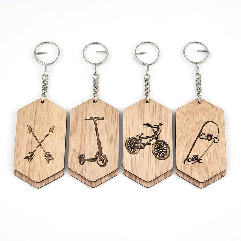 4 bag tags next to each other with arrows, scooter, bicycle and skateboard on the front