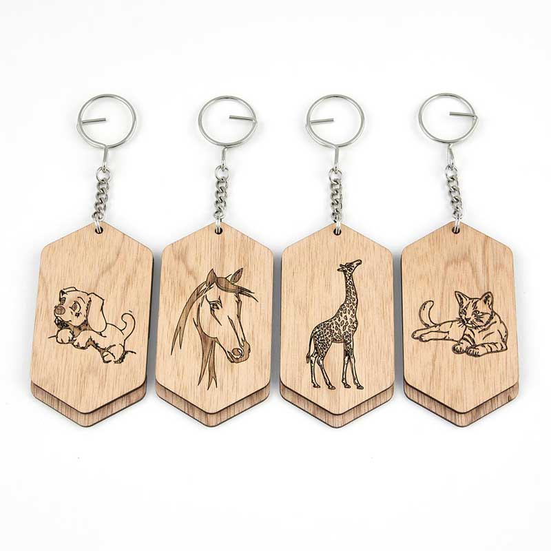 wooden bag tags with a puppy, horse,giraffe and a cat etched on them