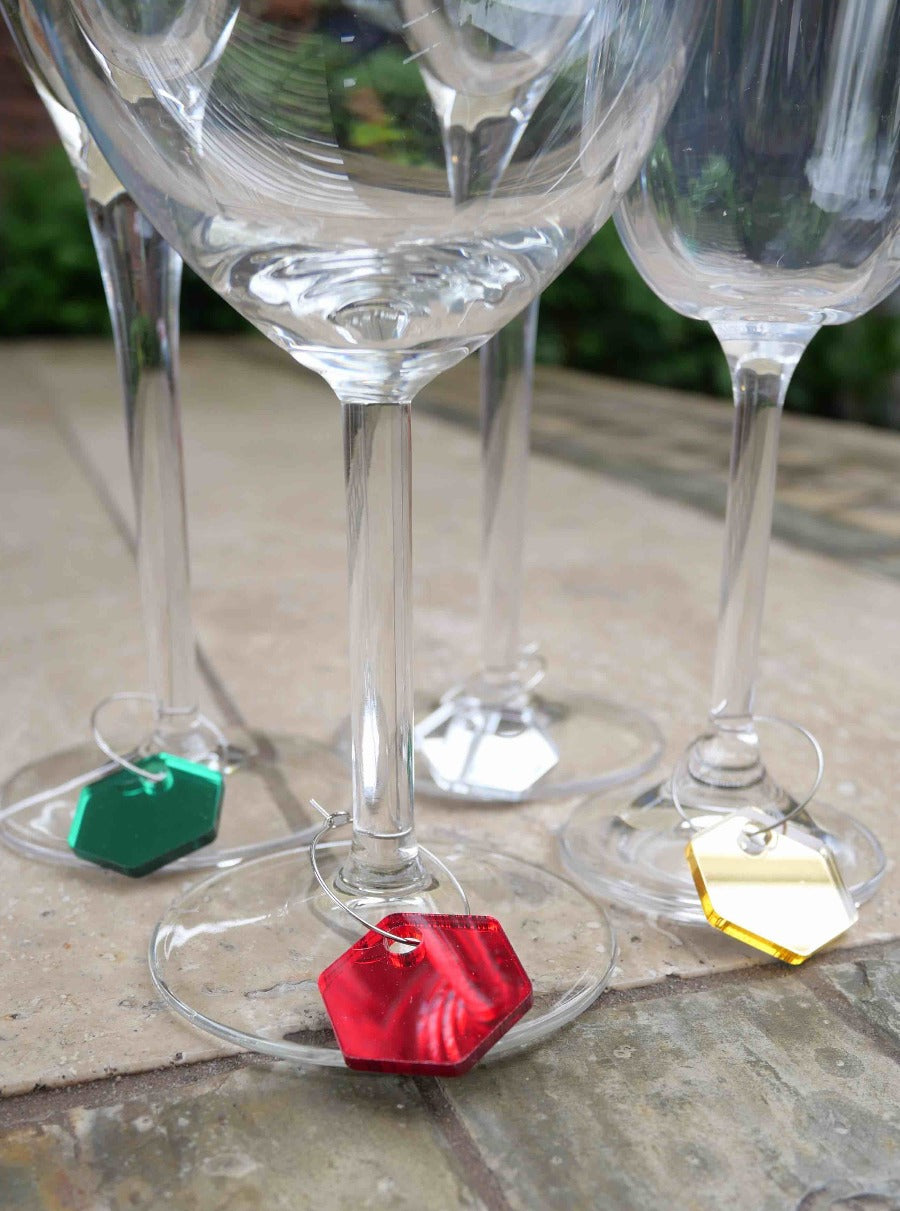 4 wine glasses with charms, red green gold and silver